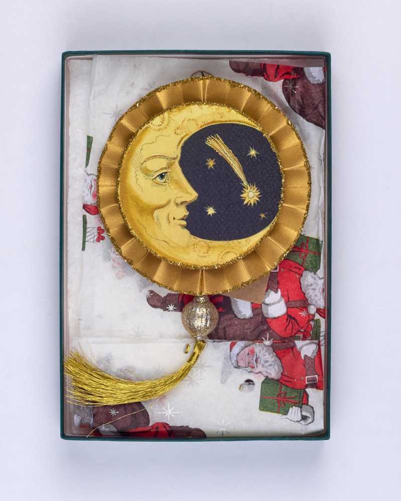 An original, handmade Christmas decoration showing crescent and full moons